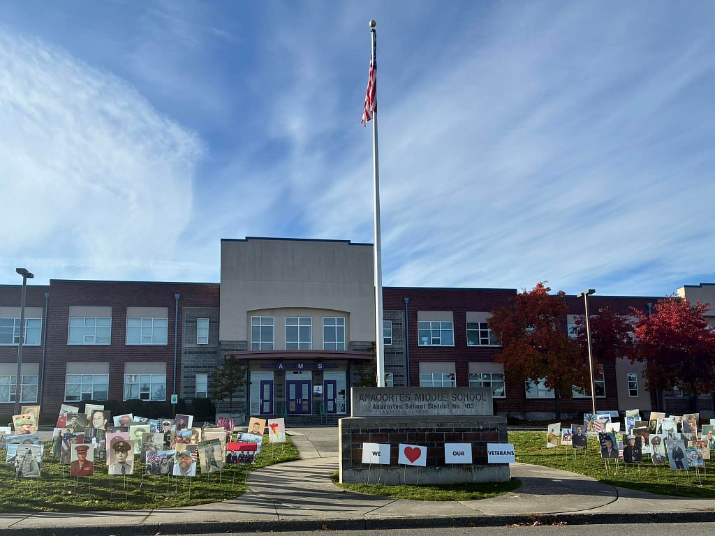 Photos of veterans on yard signs outside the Anacortes Middle School, and a set of signs that say, "We love our Veterans." The upcoming Anacortes school levies will provide essential funding to maintain our high quality extra-curricular programs, including athletics, music and arts.