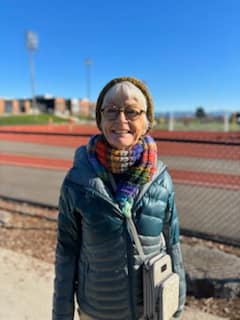 Sherry Chavers, Anacortes resident, stands outside a track stadium on a cold, sunny day. She is a strong advocate for Anacortes schools and hopes you'll join her in voting yes on the upcoming Anacortes School Levy.