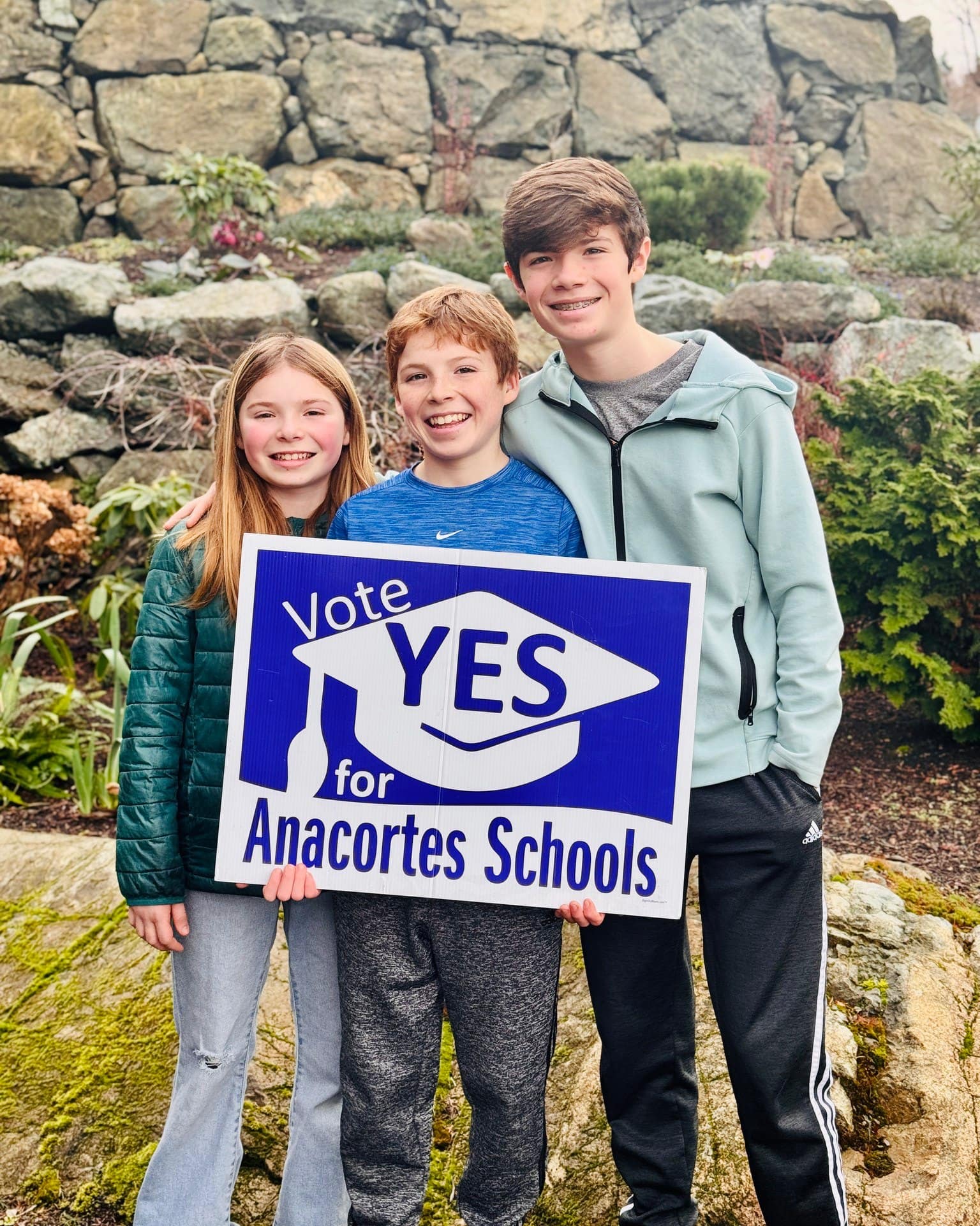 The Worthington kids hold a sign that says, "Vote YES for Anacortes Schools."